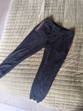 Alexander McQueen Black Jogger Pants with Red Logo Tape